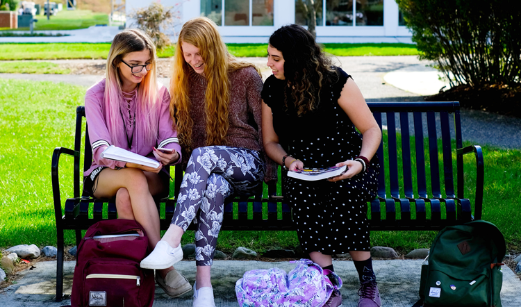 fenxiong.net three female students studying on a bench on camp at Ocean County College